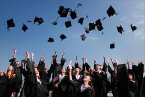 image of graduates tossing their hats